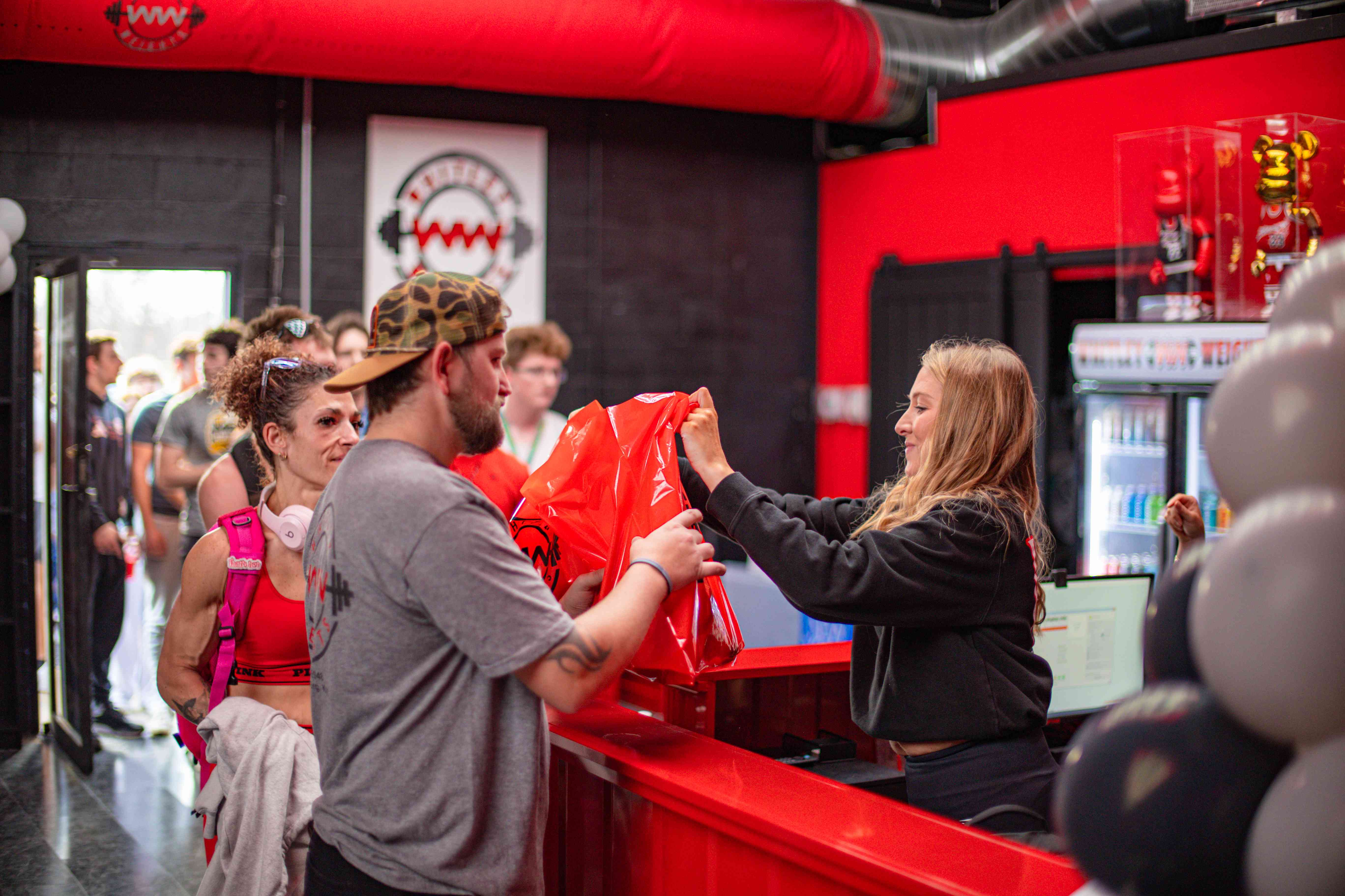 Staff handing out Whitley Weights swag bags at the front desk