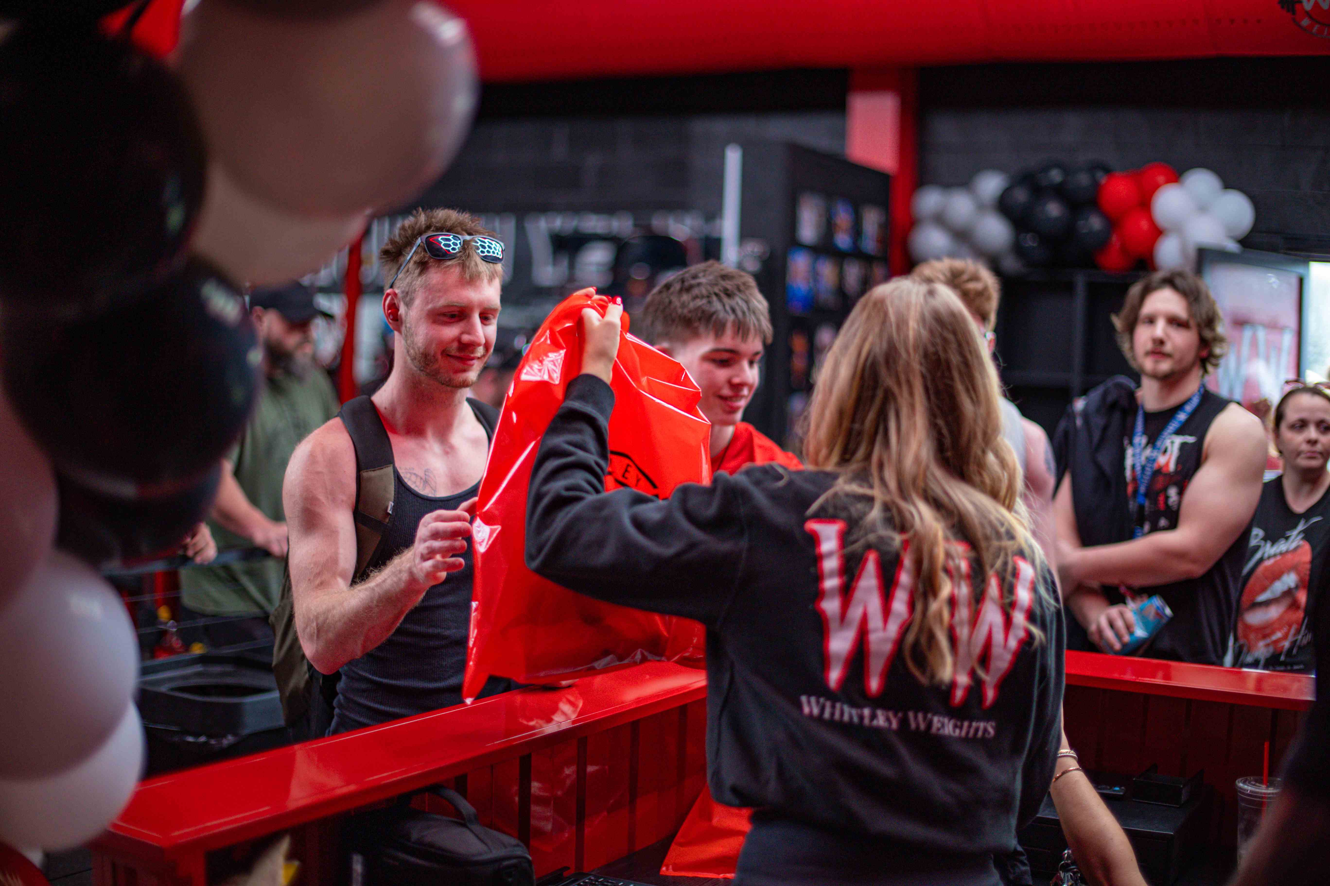 Staff in Whitley Weights gear handing out swag bags