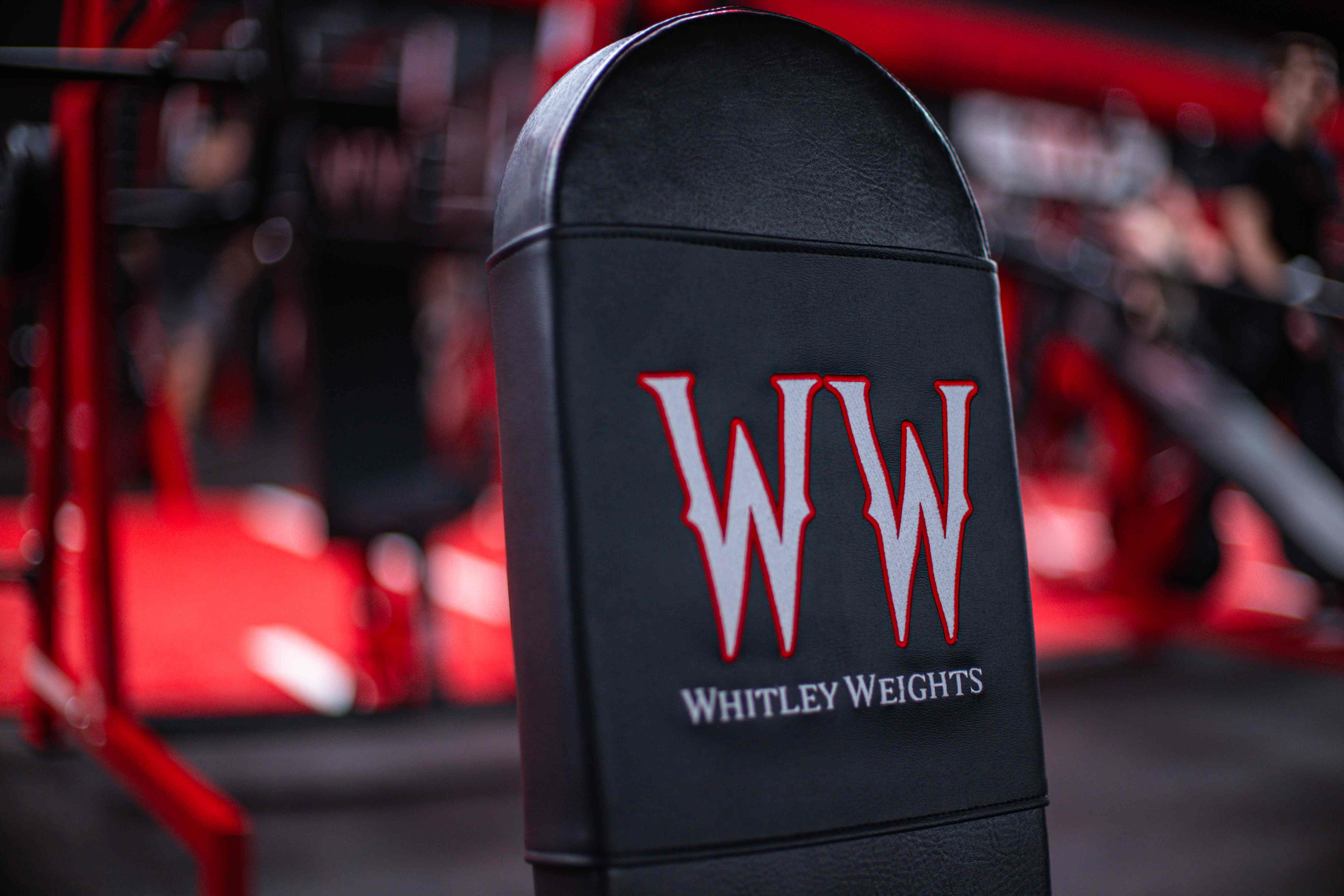 Whitley Weights logo embroidered on a black machine pad